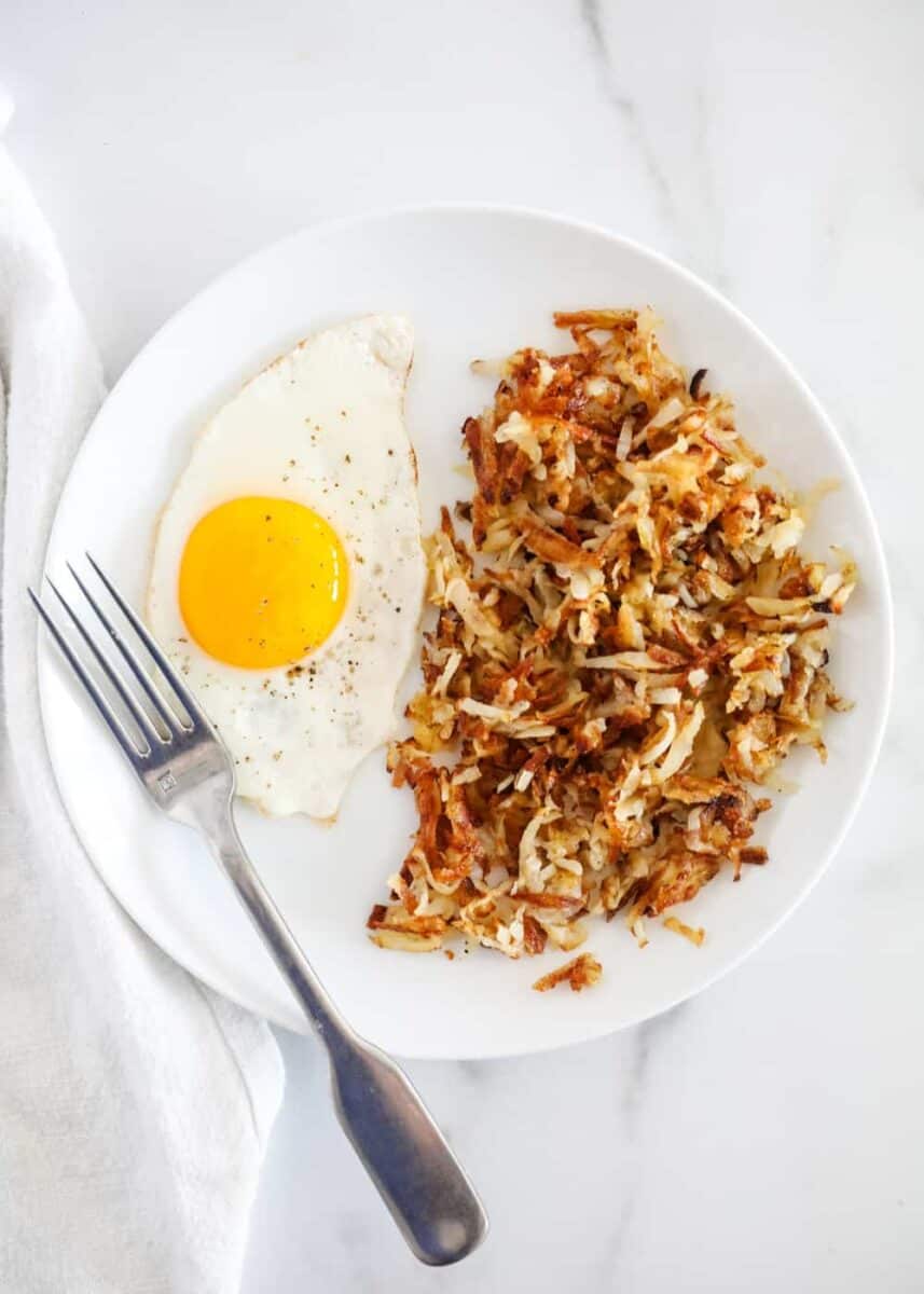 plate of hash browns with egg