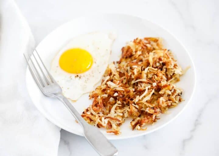 hash browns with a fried egg on a plate 