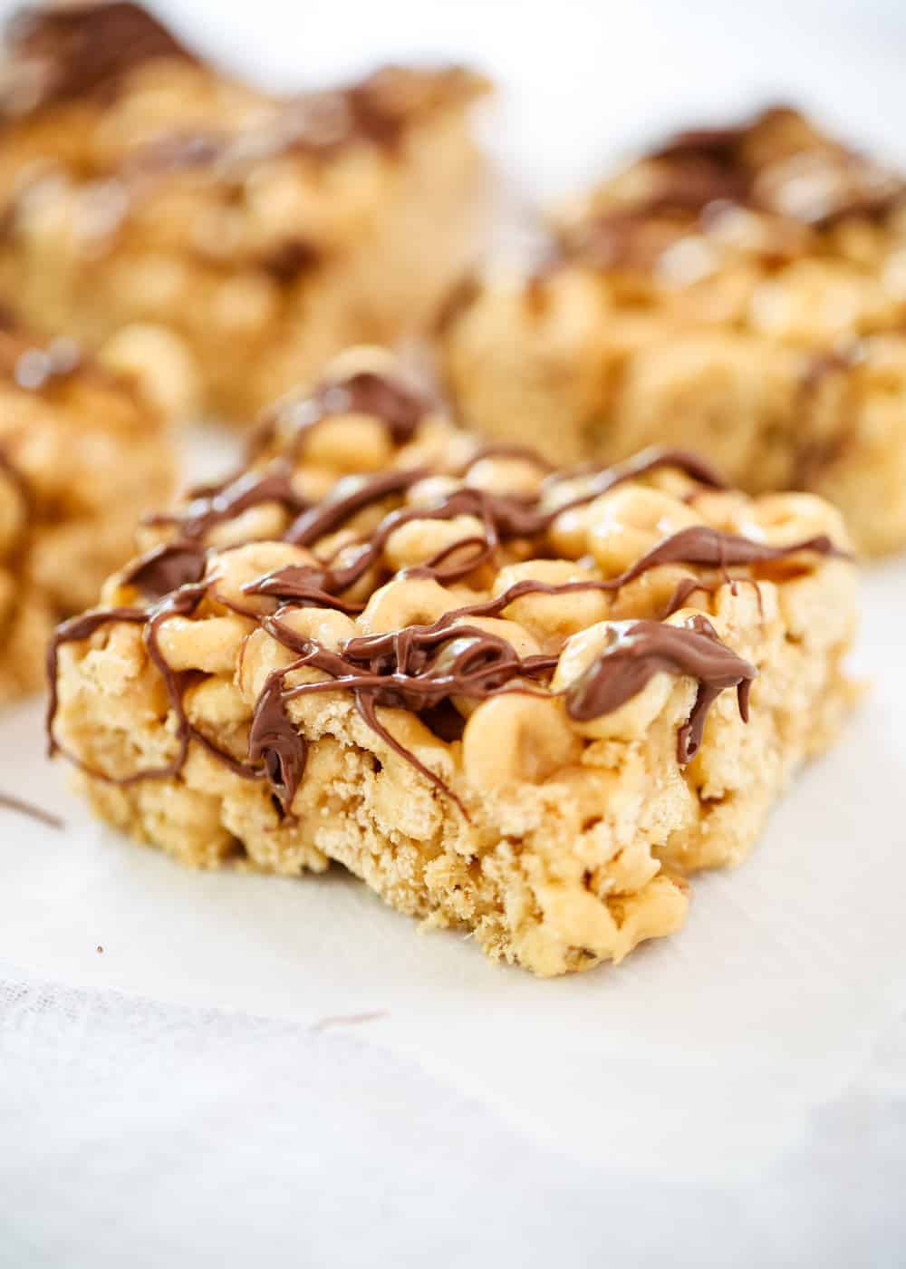 Peanut butter cheerio bar with chocolate drizzled on top.