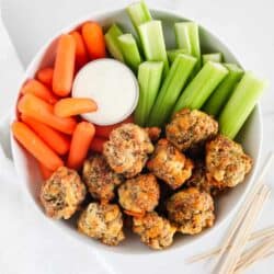 sausage balls in a white bowl with vegetables