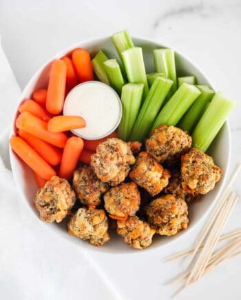 sausage balls in a white bowl with vegetables