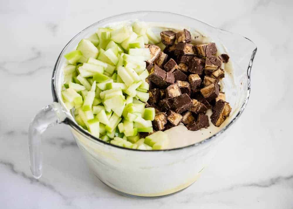snickers and apple salad in glass bowl