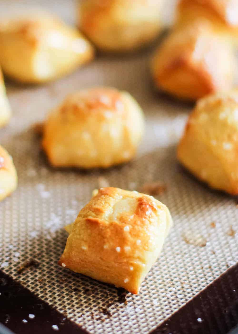 Easy homemade pretzel bites brushed with melted butter and sea salt. This easy pretzel recipe makes the perfect appetizer or snack! Always a big crowd pleaser and gone in minutes! soft pretzel bites topped with salt