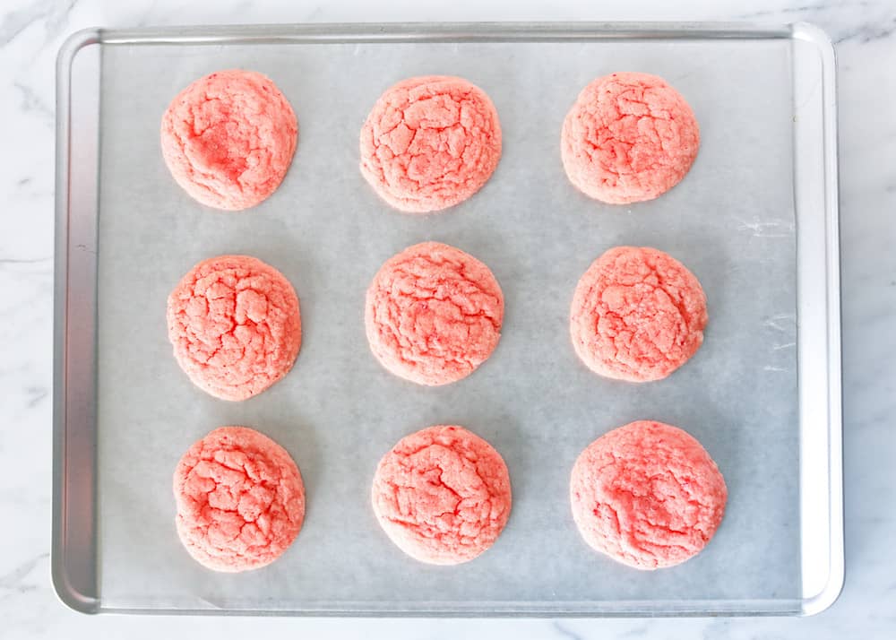 Strawberry cookies on a baking sheet.