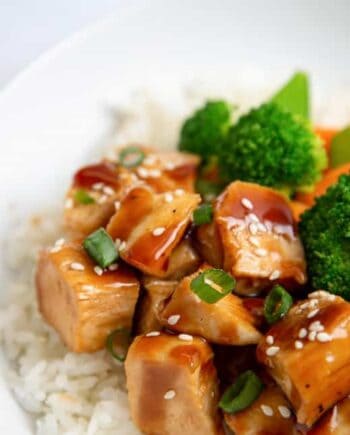 close up of teriyaki chicken in a bowl with rice and veggies