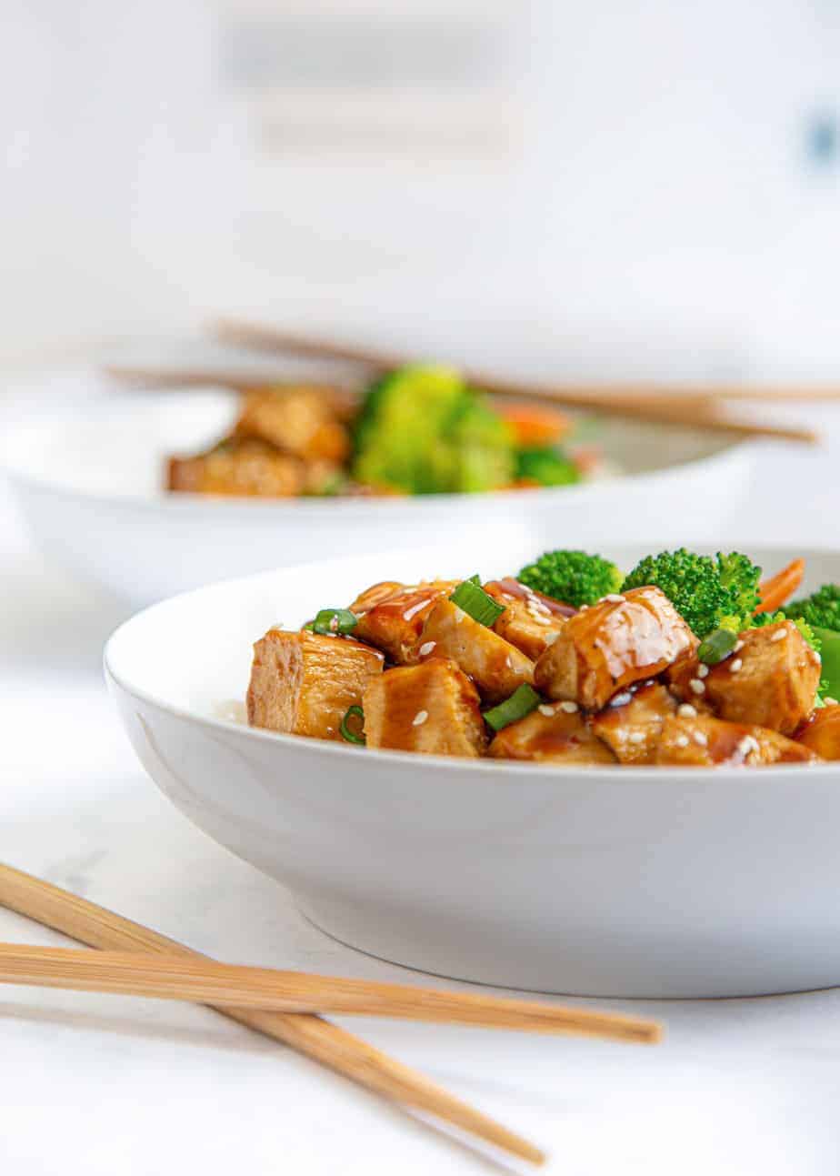 Teriyaki chicken rice bowl with chopsticks.