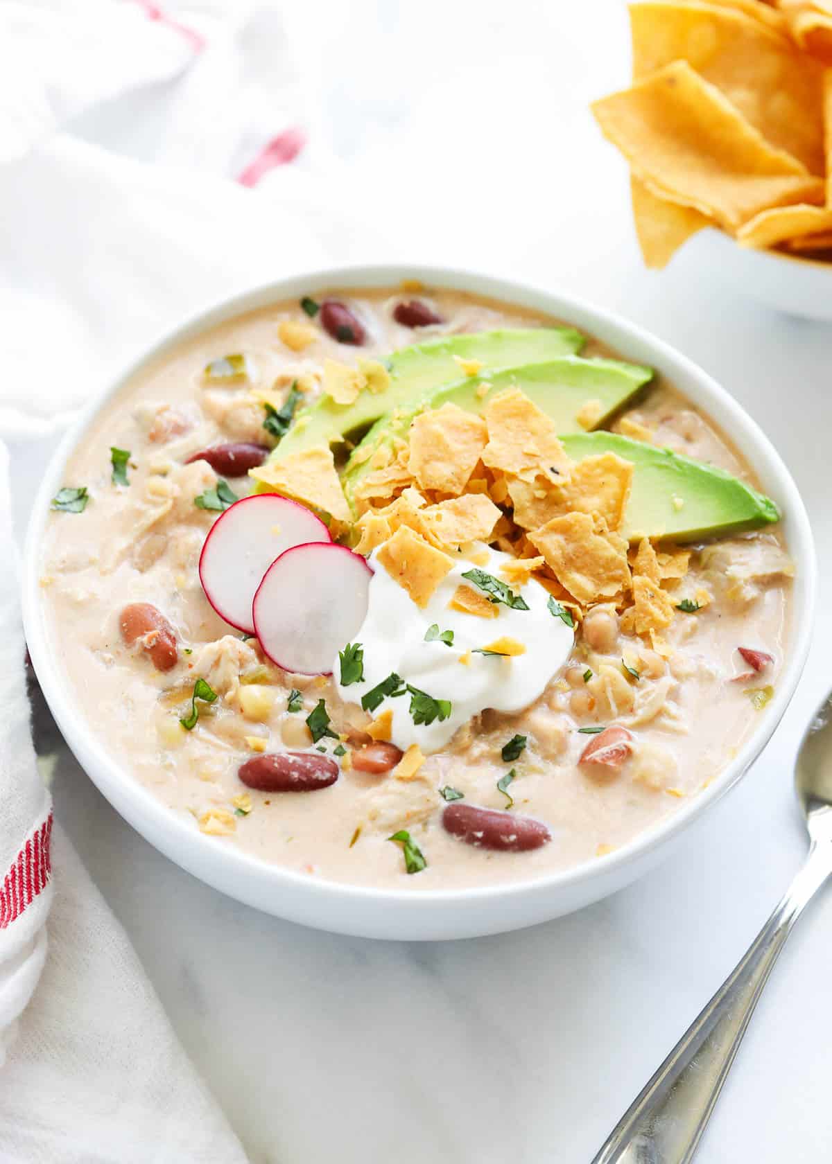 Crockpot white chicken chili served in a white bowl.
