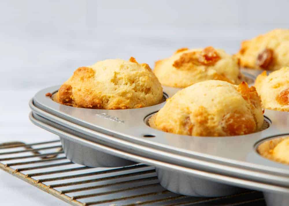 Apricot muffins in a muffin tin.