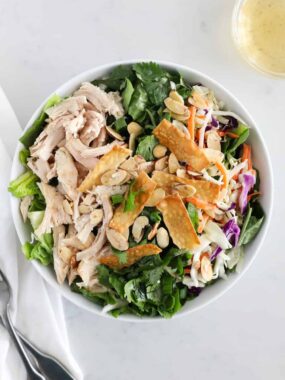 asian chicken salad in white bowl