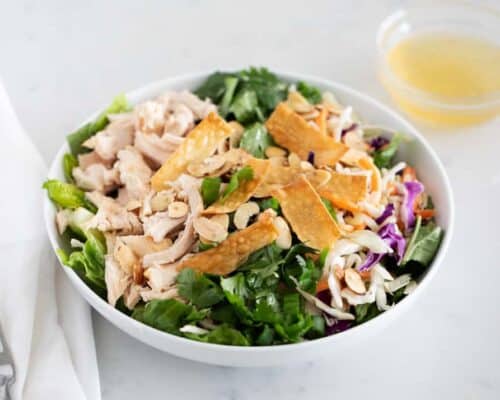 asian chicken salad in a white bowl