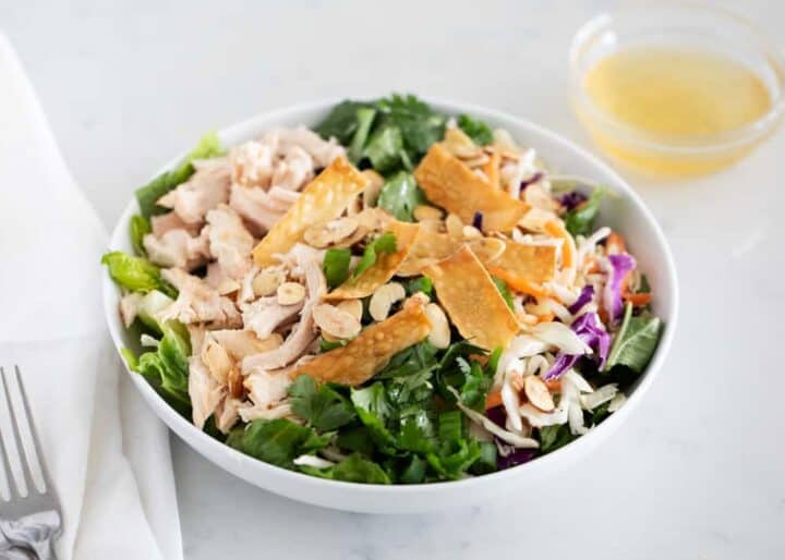 asian chicken salad in a white bowl