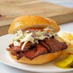 A BBQ brisket sandwich with coleslaw on a plate