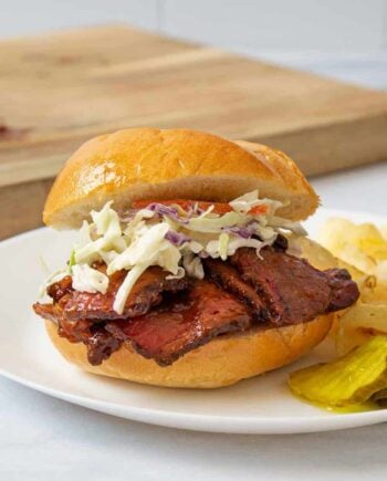 A BBQ brisket sandwich with coleslaw on a plate
