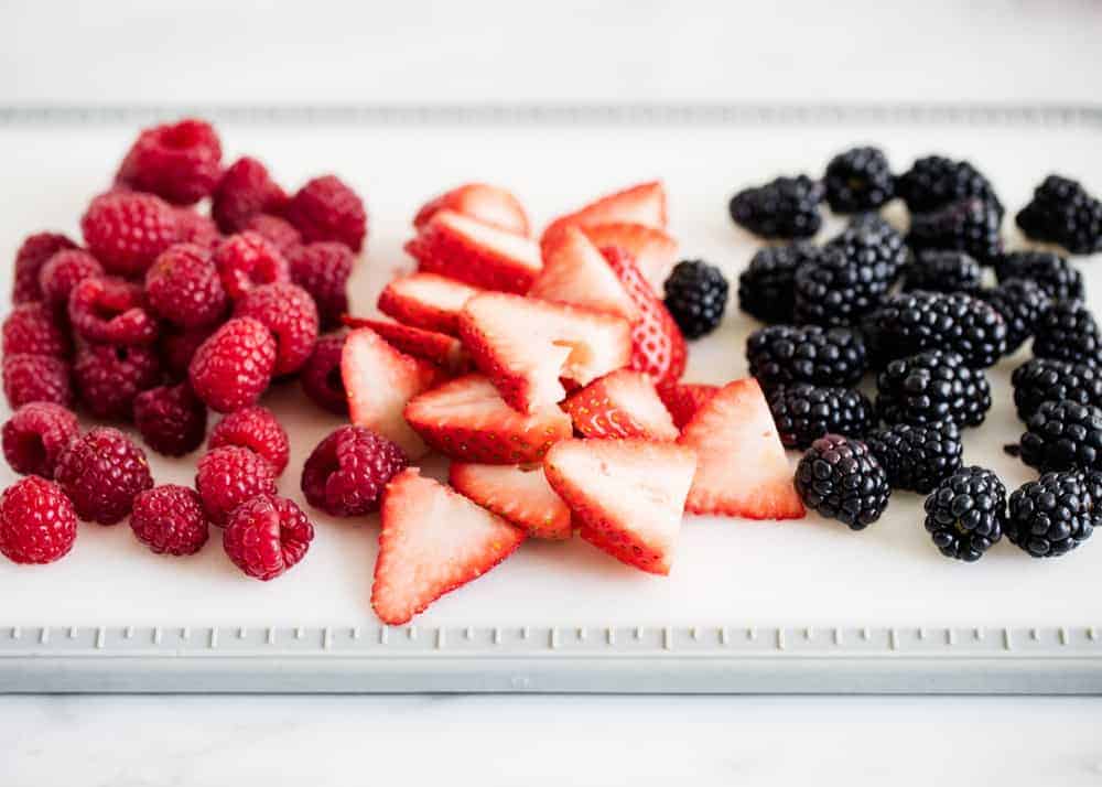 Fresh berries on a cutting board.