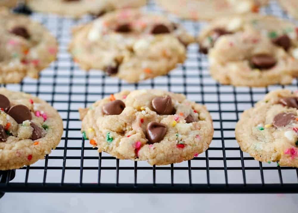 Sprinkle birthday cookies on a cooling rack.