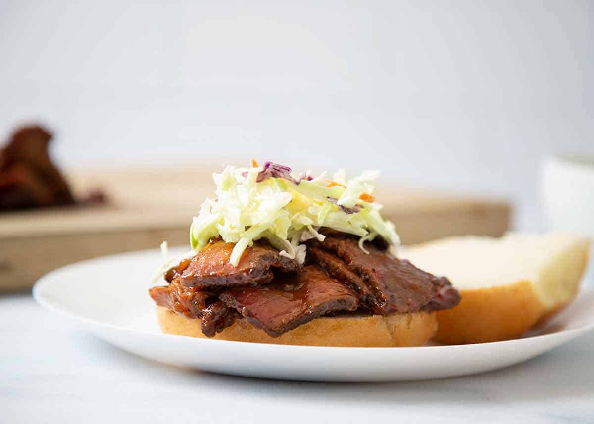 BBQ brisket sandwich topped with coleslaw.