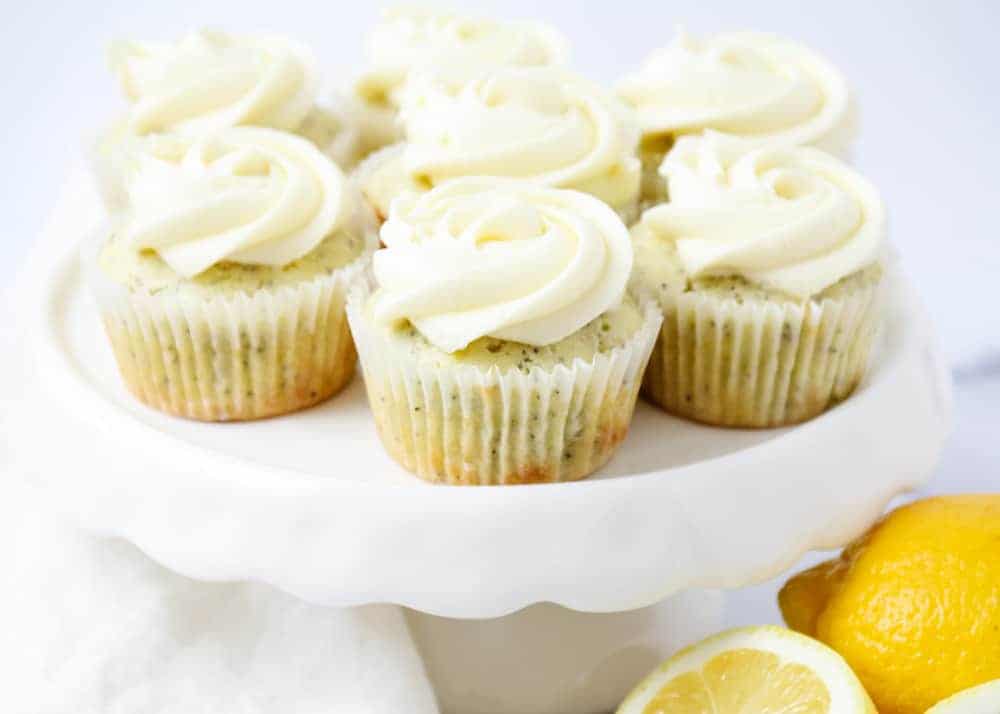 Lemon poppy seed cupcakes on a cake stand.