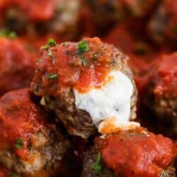 mozzarella meatballs with marinara and cheese oozing out