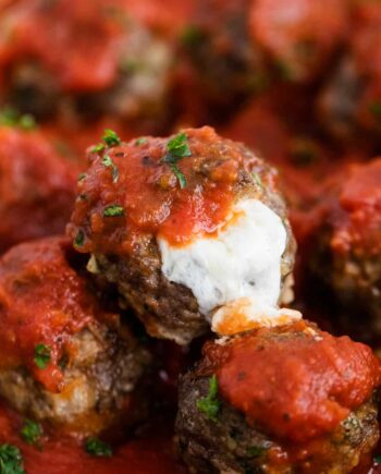mozzarella meatballs with marinara and cheese oozing out