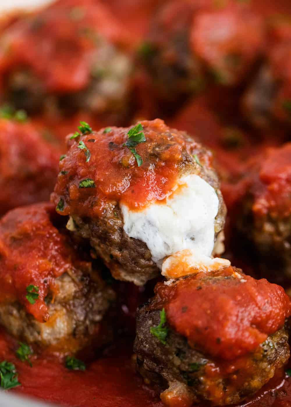 Mozzarella stuffed meatballs with marinara.