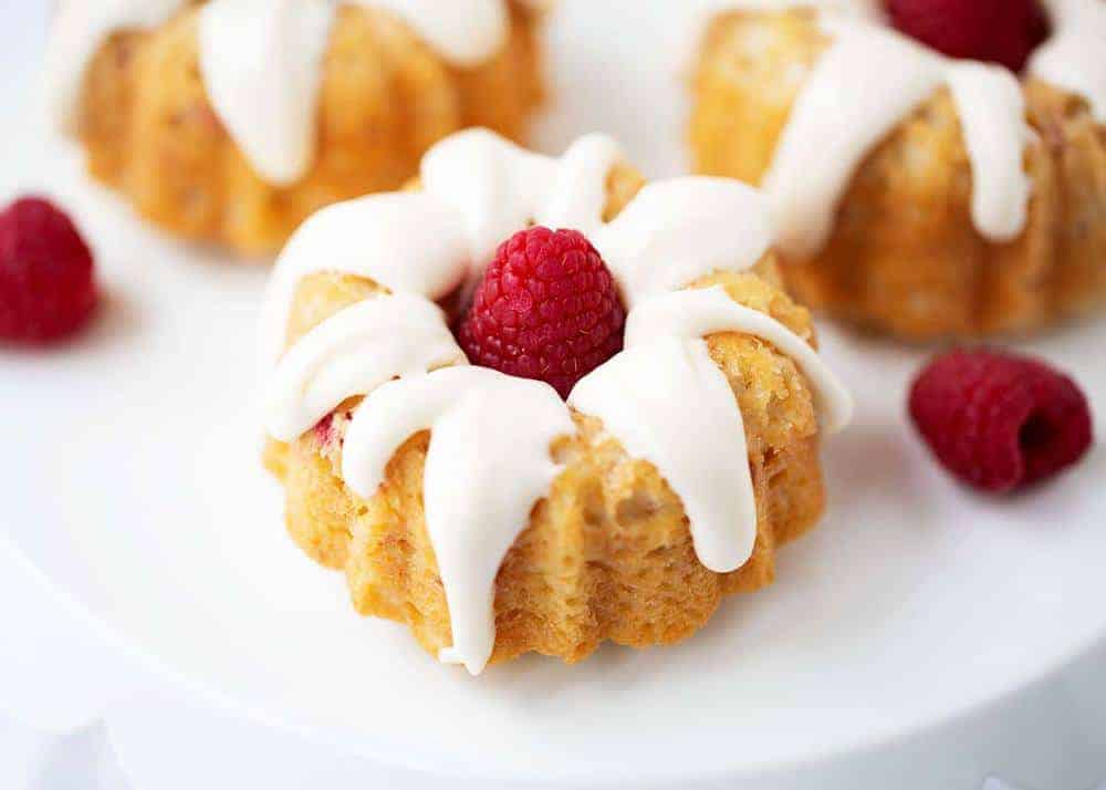 Mini raspberry bundt cake with cream cheese glaze.