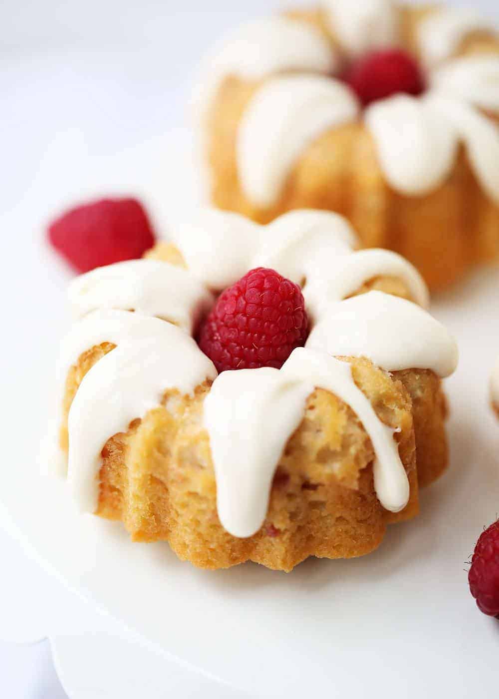 Mini raspberry bundt cake topped with cream cheese glaze.