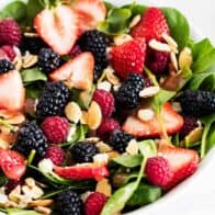 spinach salad with fresh berries and sliced almonds