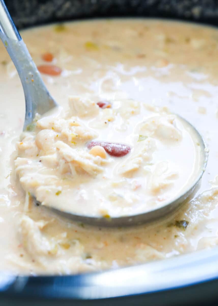 Ladle full of white chicken chili.