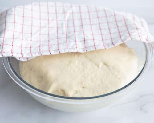 dough in bowl with towel on top