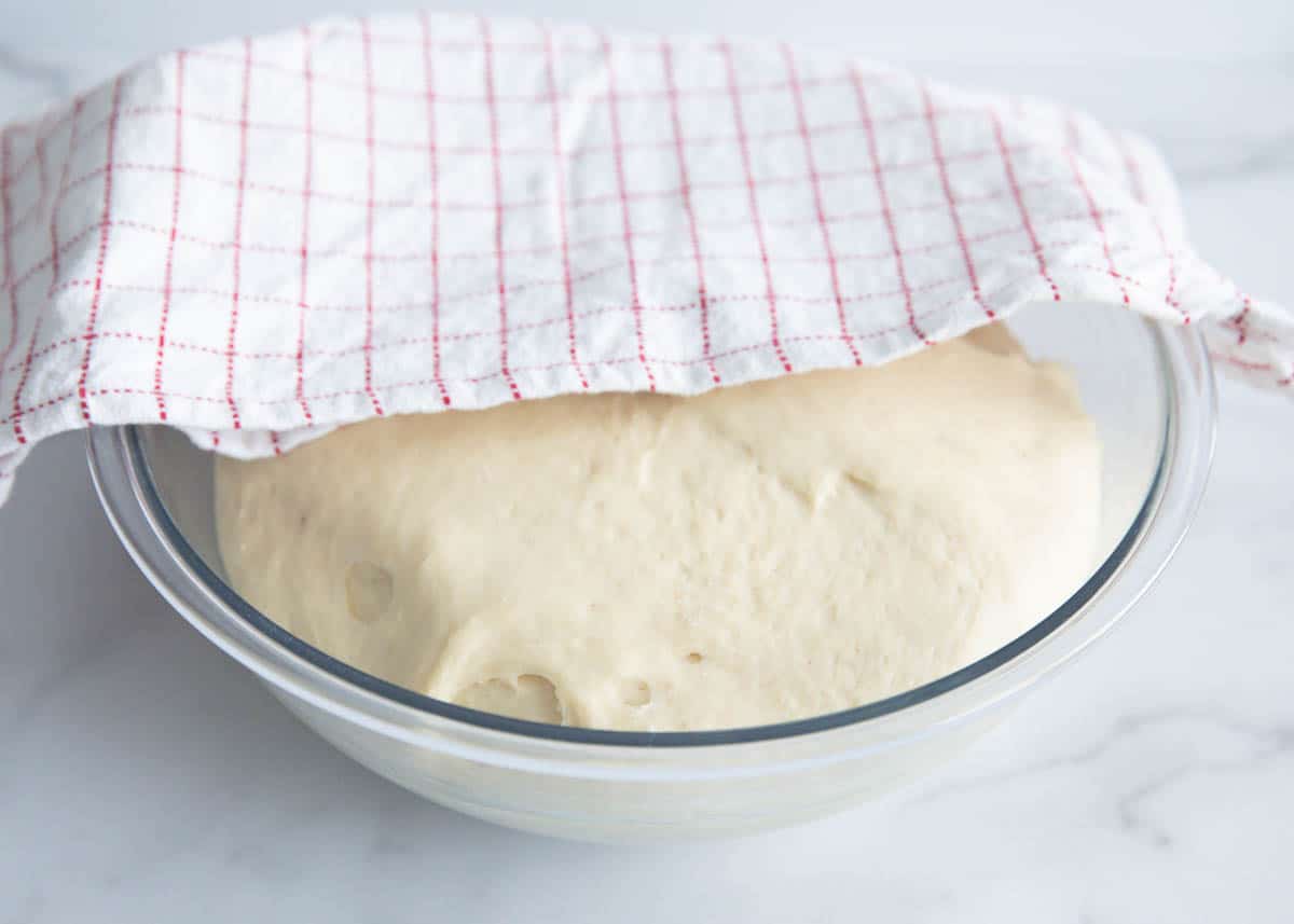 dough in bowl with towel on top