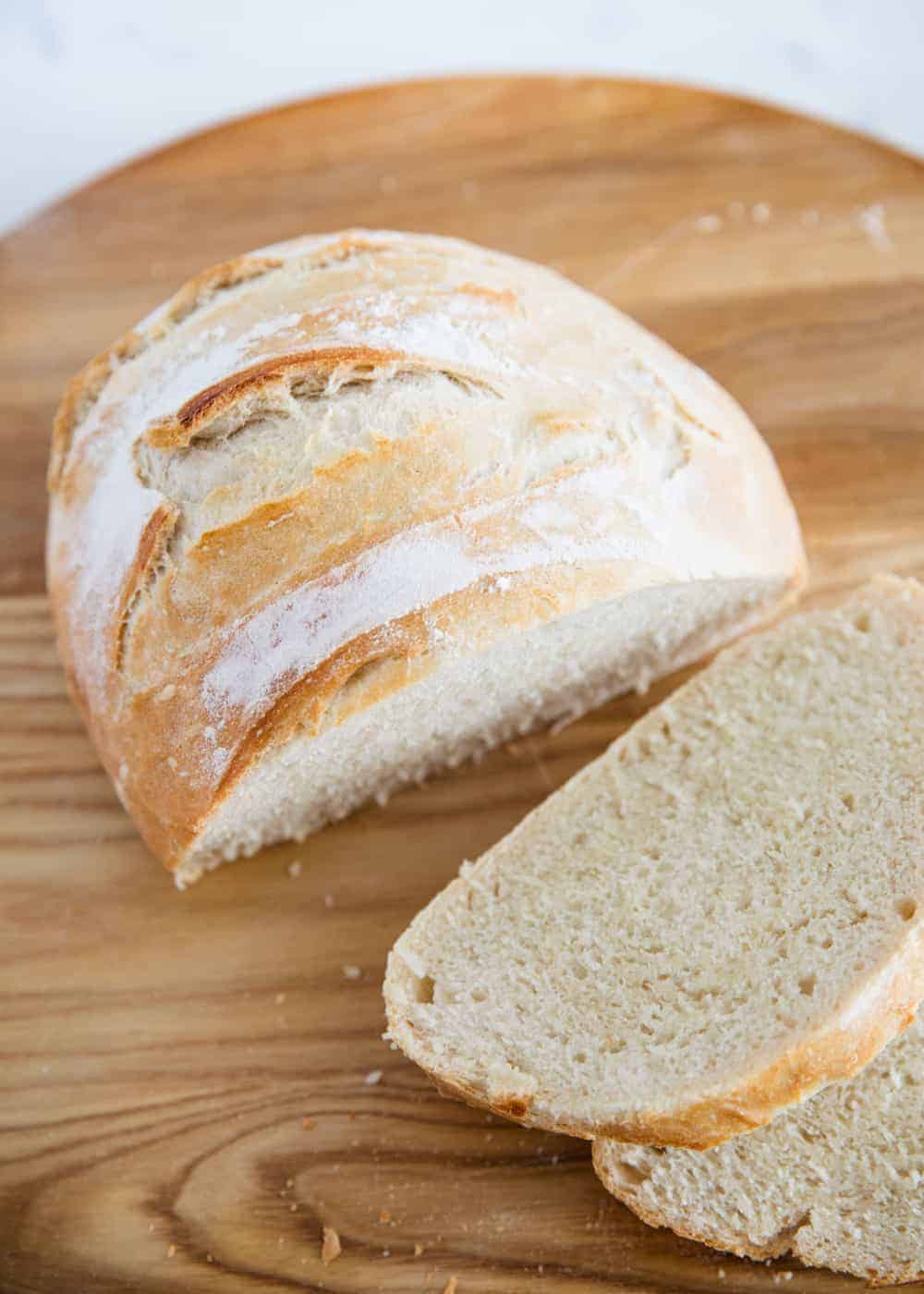 Sliced artisan bread on cutting board.