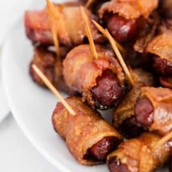 bacon wrapped smokies on white plate