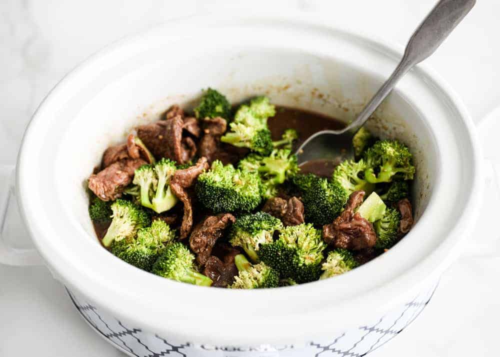 Beef and broccoli cooking in crockpot.