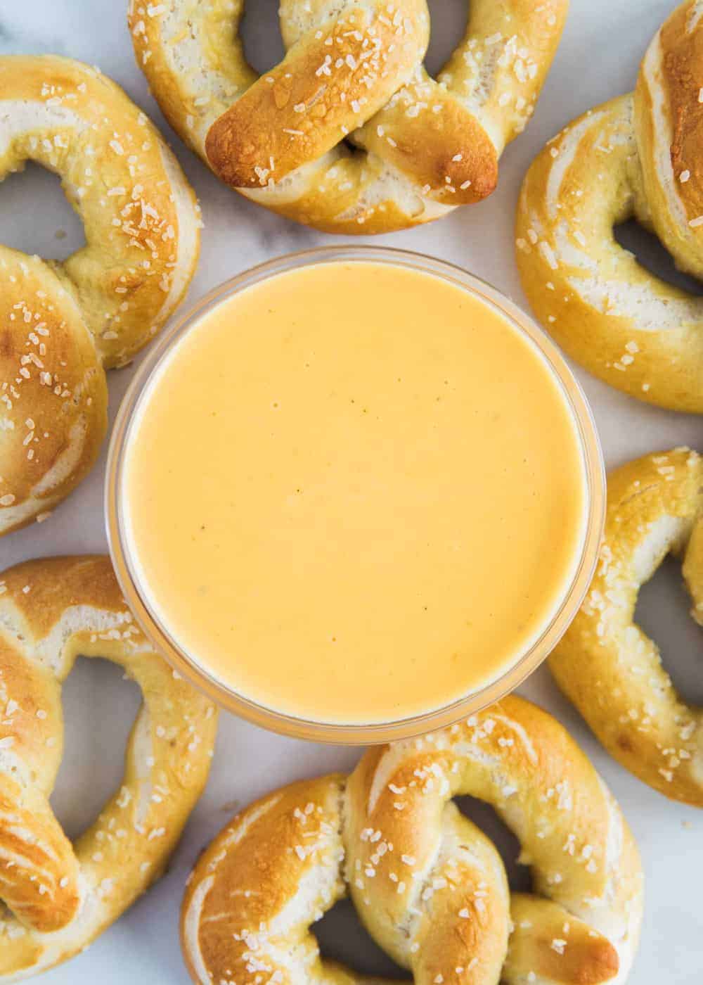 Cheese dip for pretzels in glass bowl.