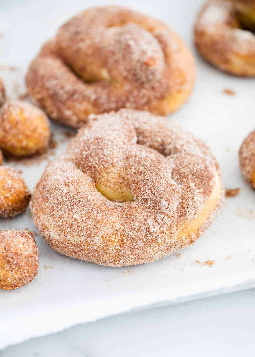 Cinnamon sugar pretzels on parchment paper.