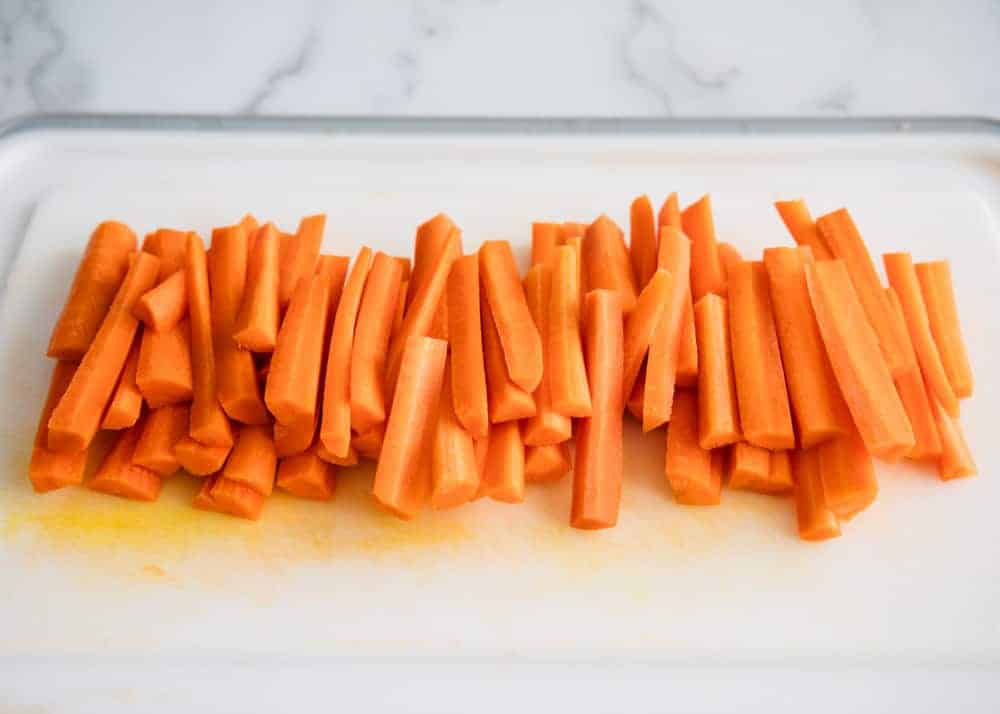 Sliced carrots on cutting board.