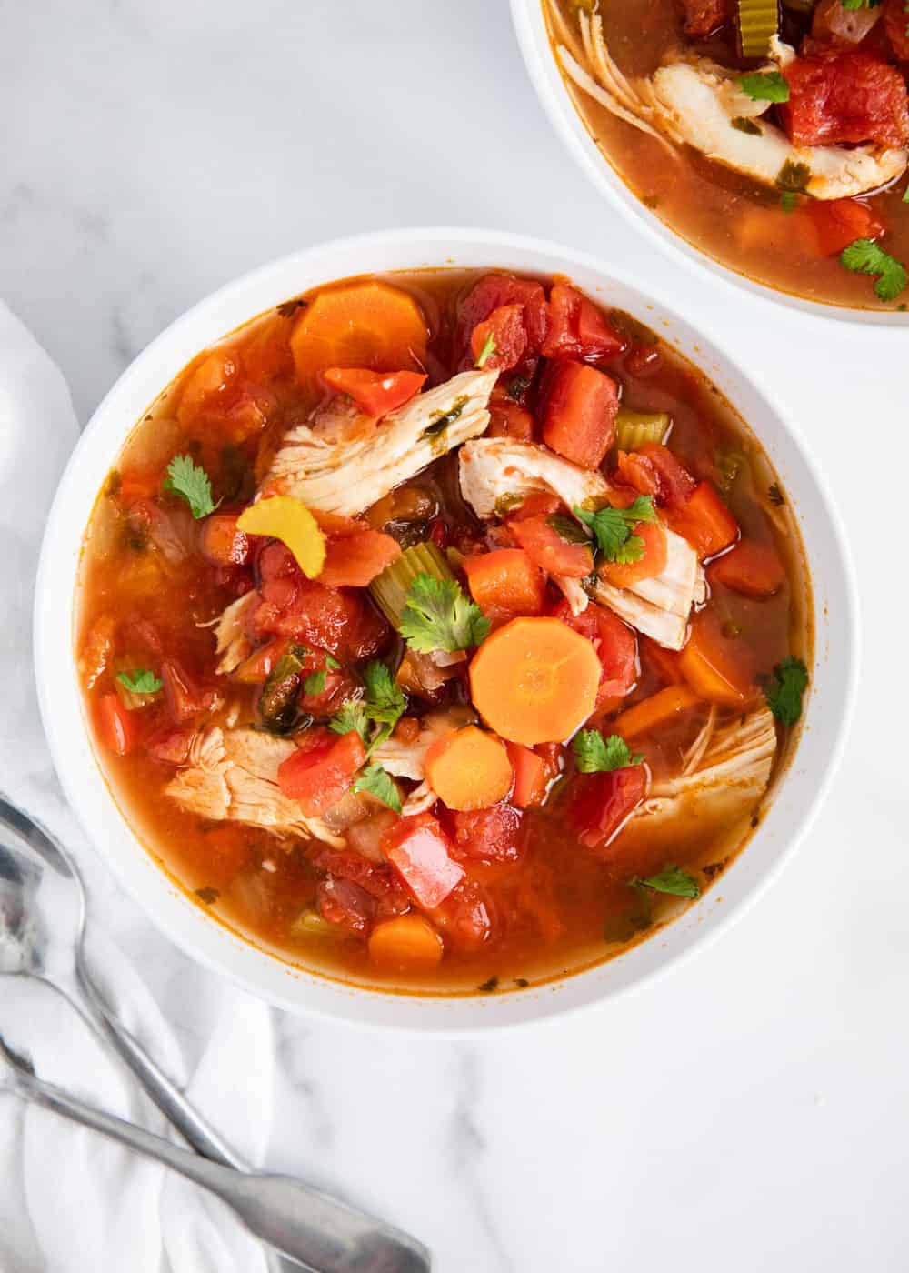 Mexican chicken soup in white bowl.