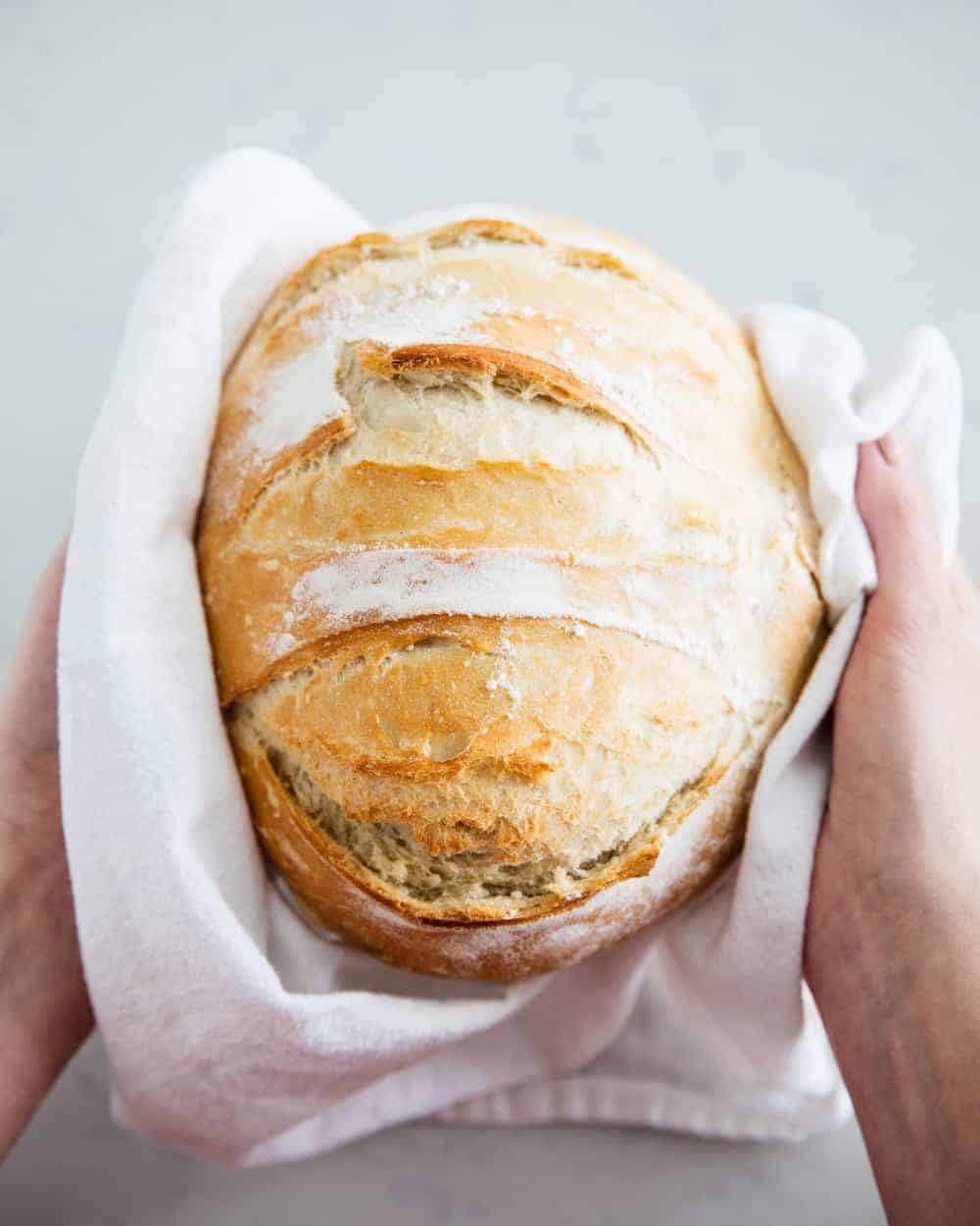 Handing holding artisan bread.