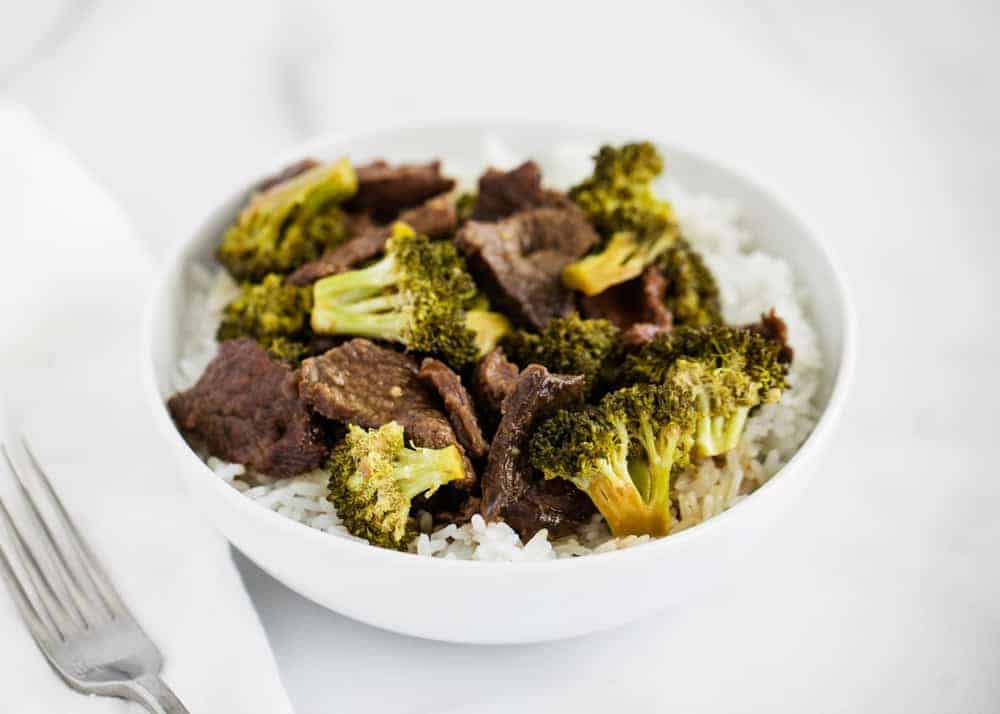 Beef and broccoli in a white bowl.