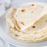 homemade flour tortillas on a white plate