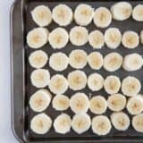 sliced bananas on baking sheet