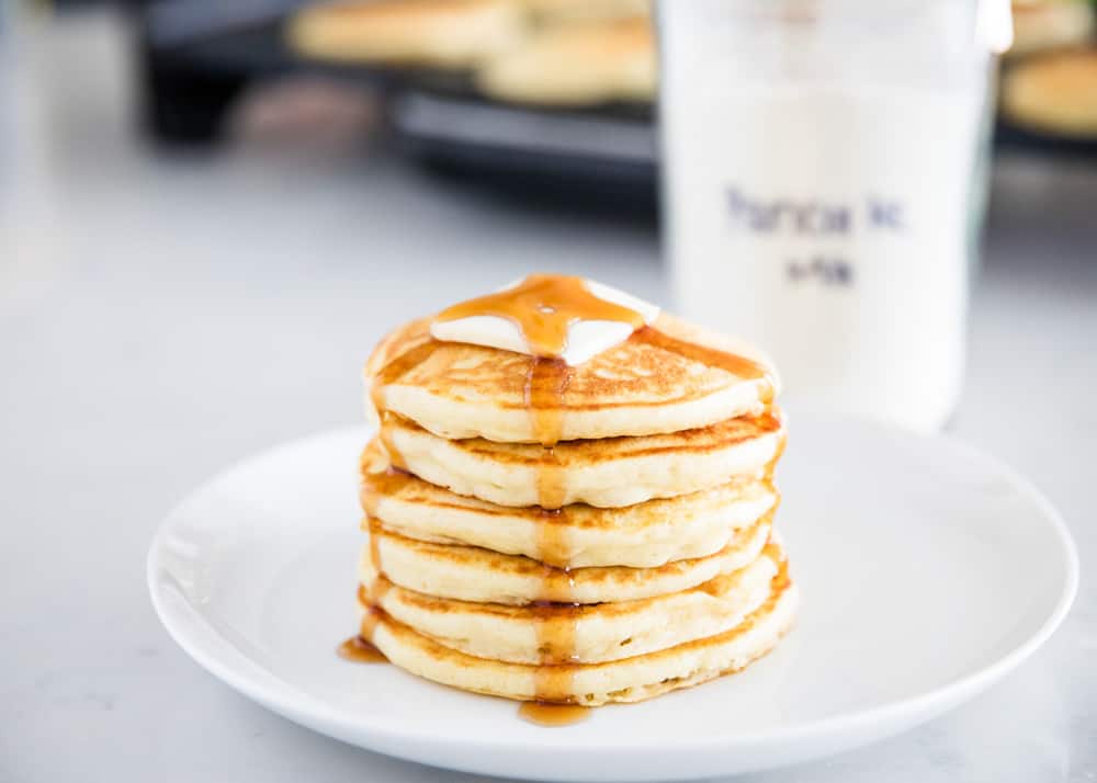 Stacked pancakes on plate.