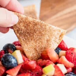 tortilla chip dipped in fruit salsa