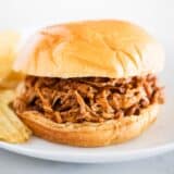 bbq pork sandwich on white plate