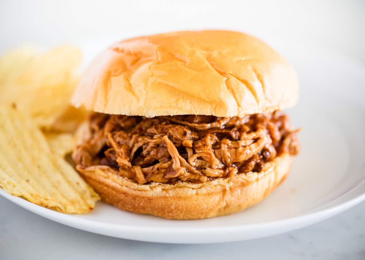 Bbq pork sandwich on white plate.