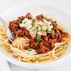 spaghetti sauce and noodles on white plate
