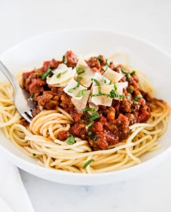 spaghetti sauce and noodles on white plate