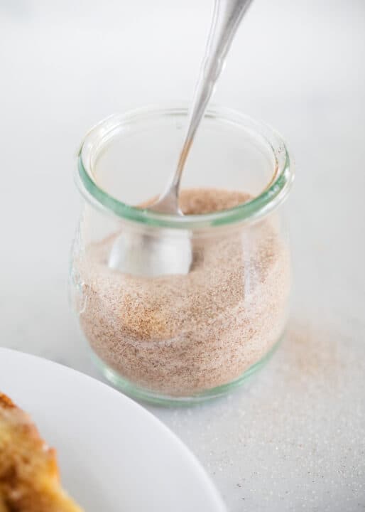 cinnamon sugar in a glass jar with spoon