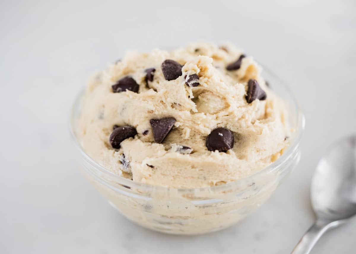 Satisfy your cravings with a spoonful of this easy edible cookie dough! Safely made with no eggs and instructions for heat treated flour. Add your favorite mix-in's and dig in! Edible cookie dough in a bowl.