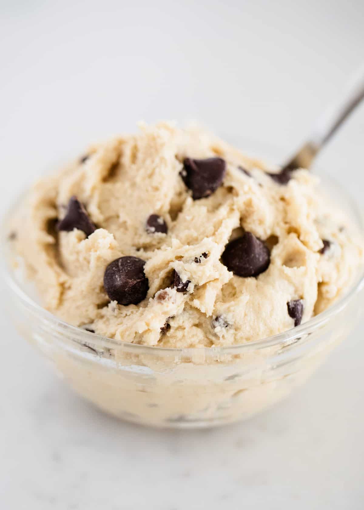 Edible cookie dough in a glass bowl.